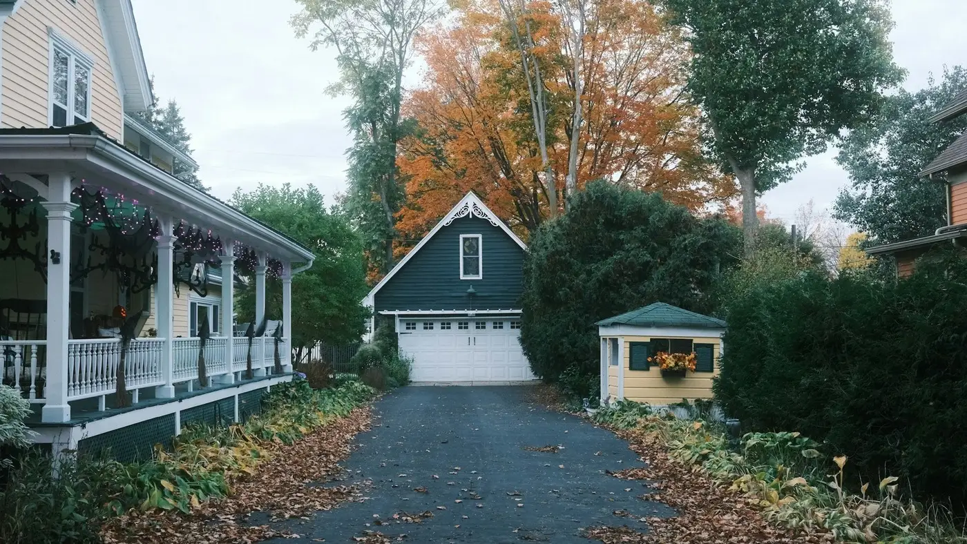 Sealed asphalt driveway running from the street to a detached garage